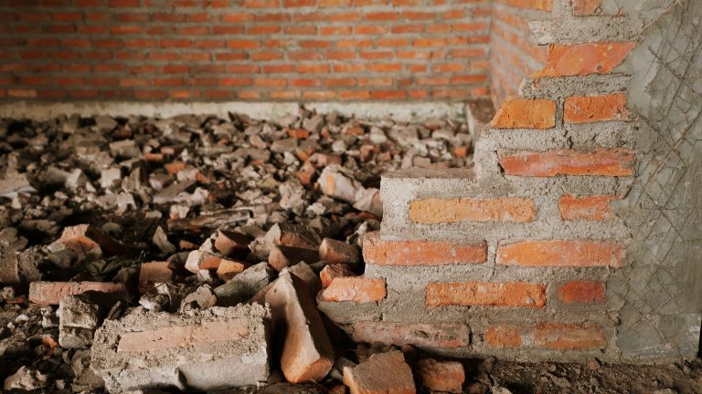 Cracked red brick illustrates the walls that divide people who disagree.